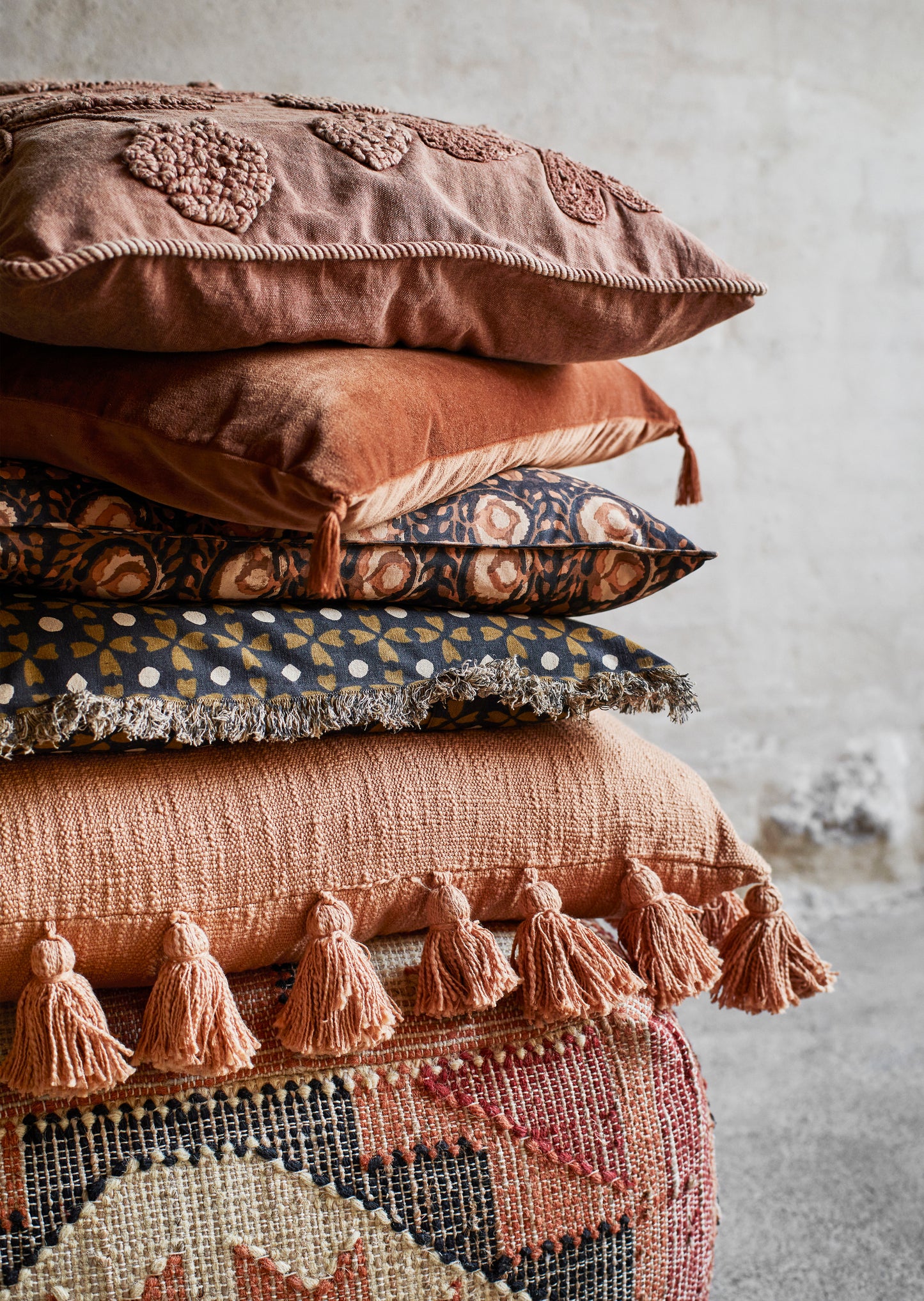 Velvet cushion cover with tassel detail in burnt orange | Minerva Interiors