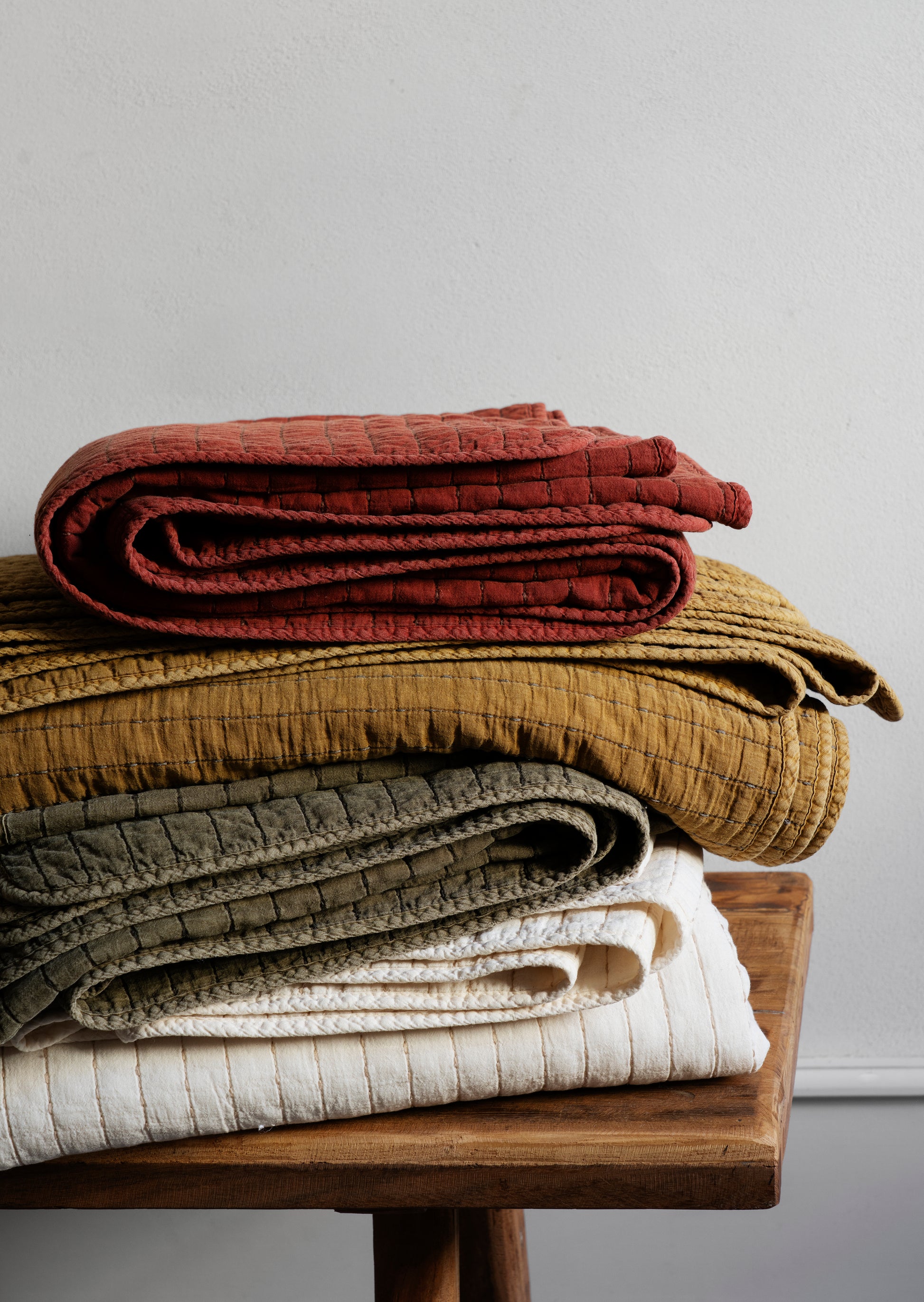 Quilted cotton bed cover in mustard gold and grey | Minerva Interiors