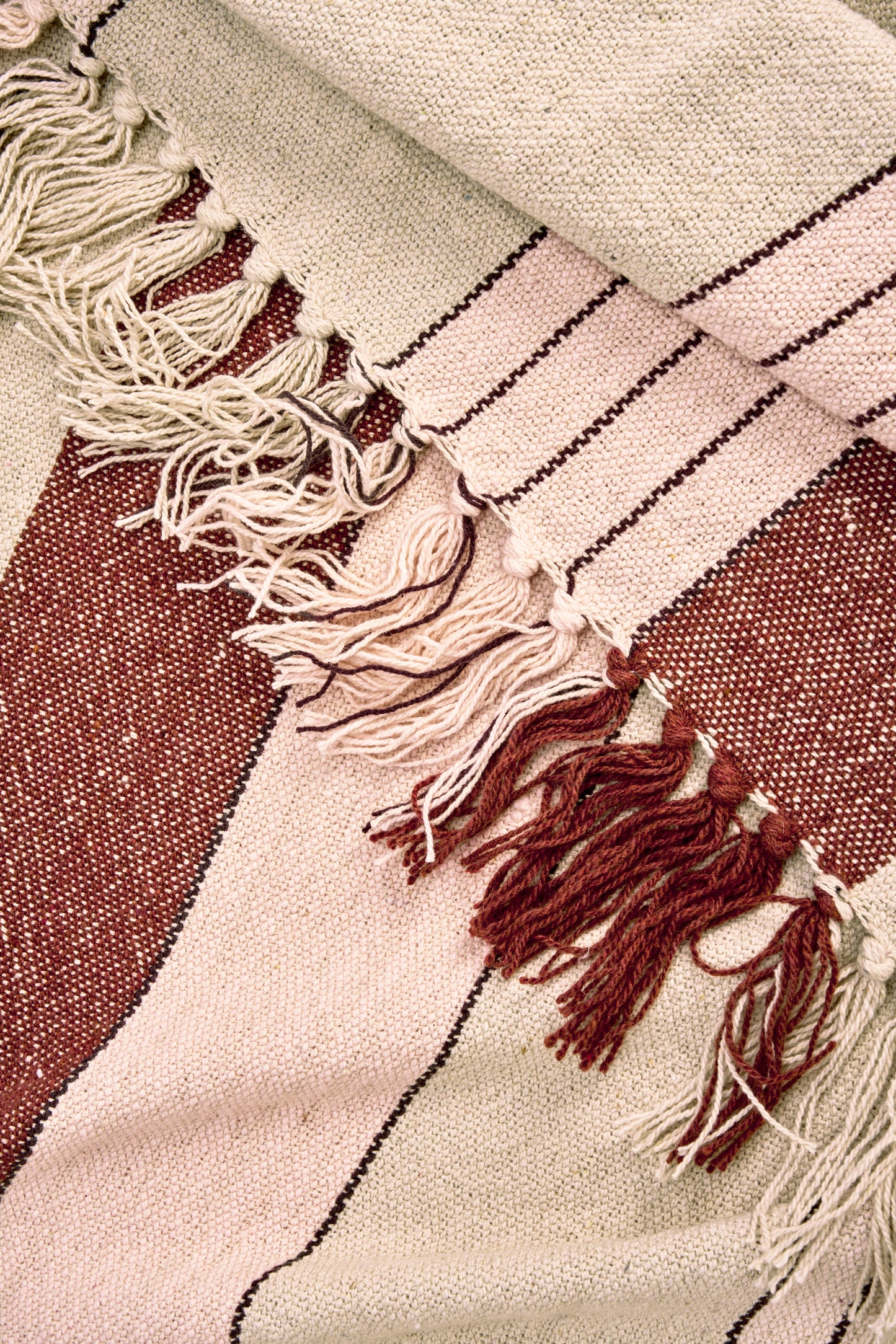 Cotton throw in off white, almond, light pink and black | Minerva Interiors