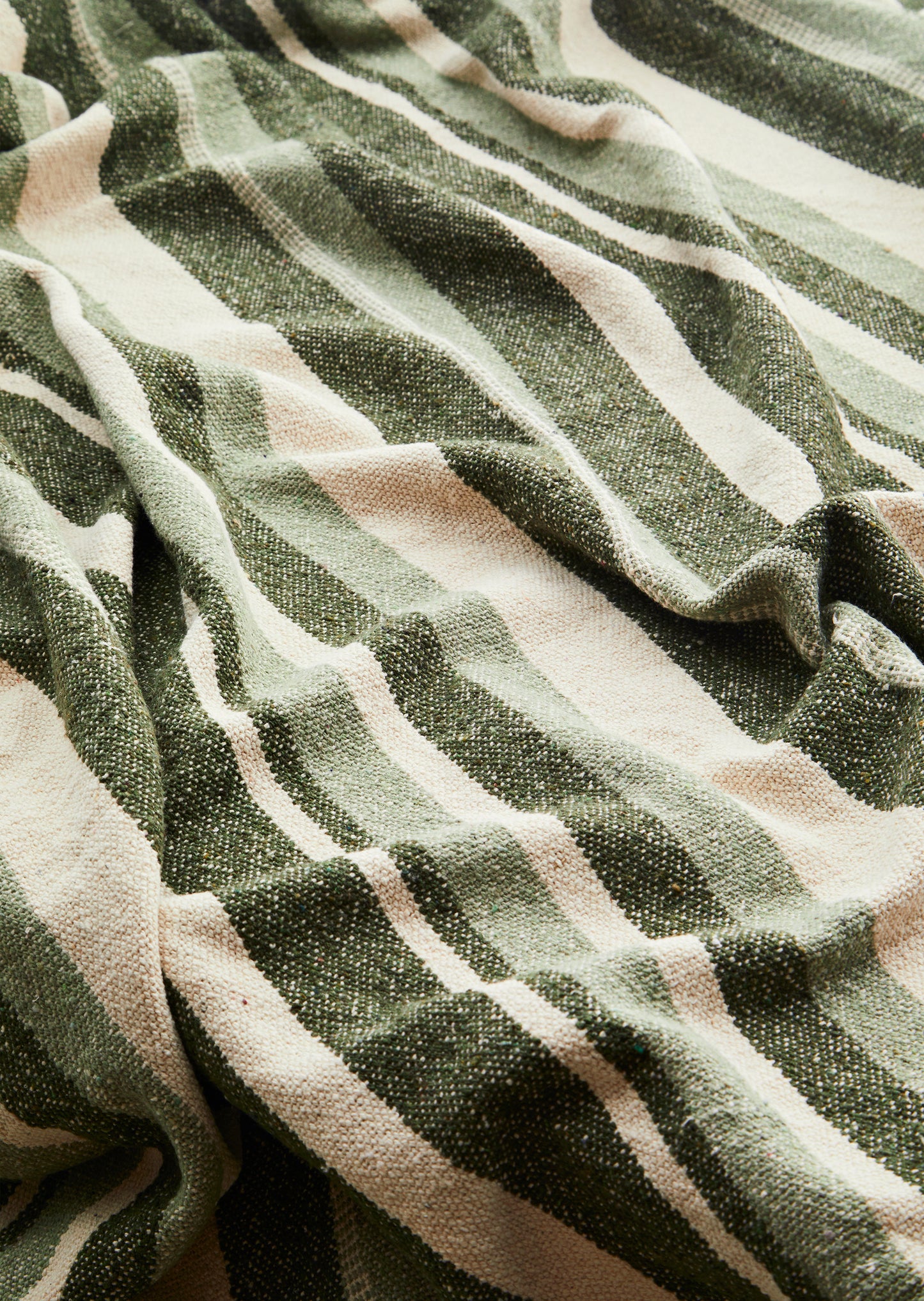Cotton throw in off white, dark green and sage | Minerva Interiors