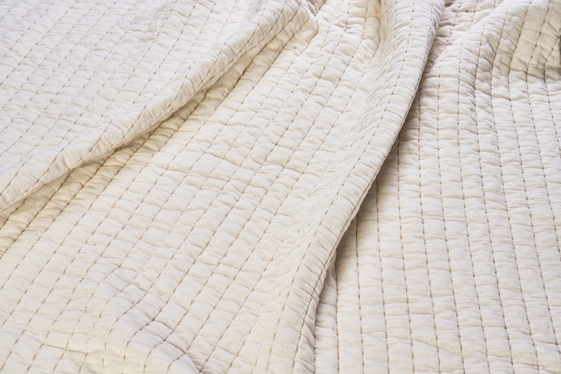 Quilted cotton bed cover in ivory and beige | Minerva Interiors