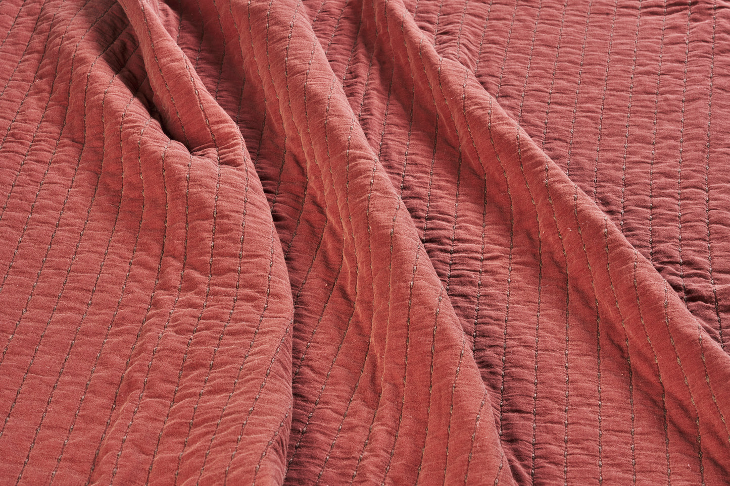 Quilted cotton bed cover and throw in brick and brown | Minerva Interiors