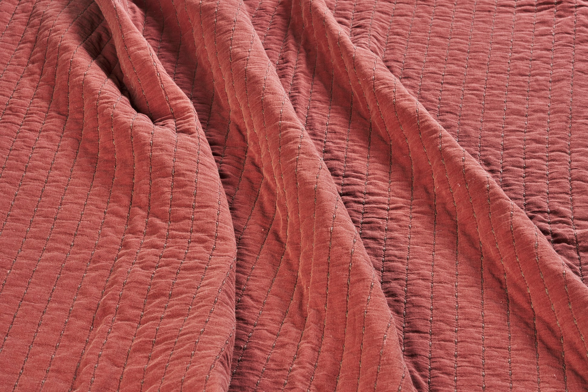 Quilted cotton bed cover and throw in brick and brown | Minerva Interiors